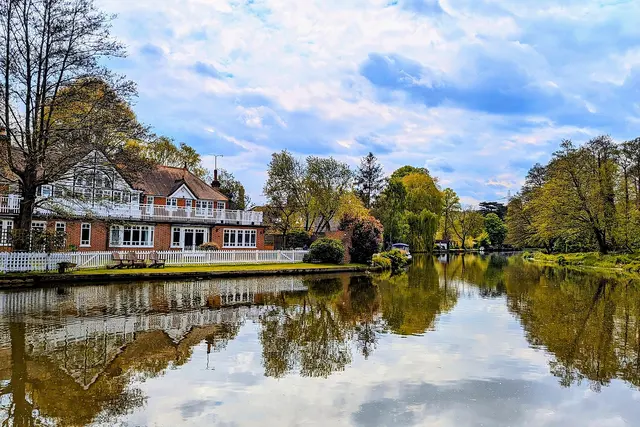 The River Wey beside Wey Road, Weybridge, with trees reflected in the water